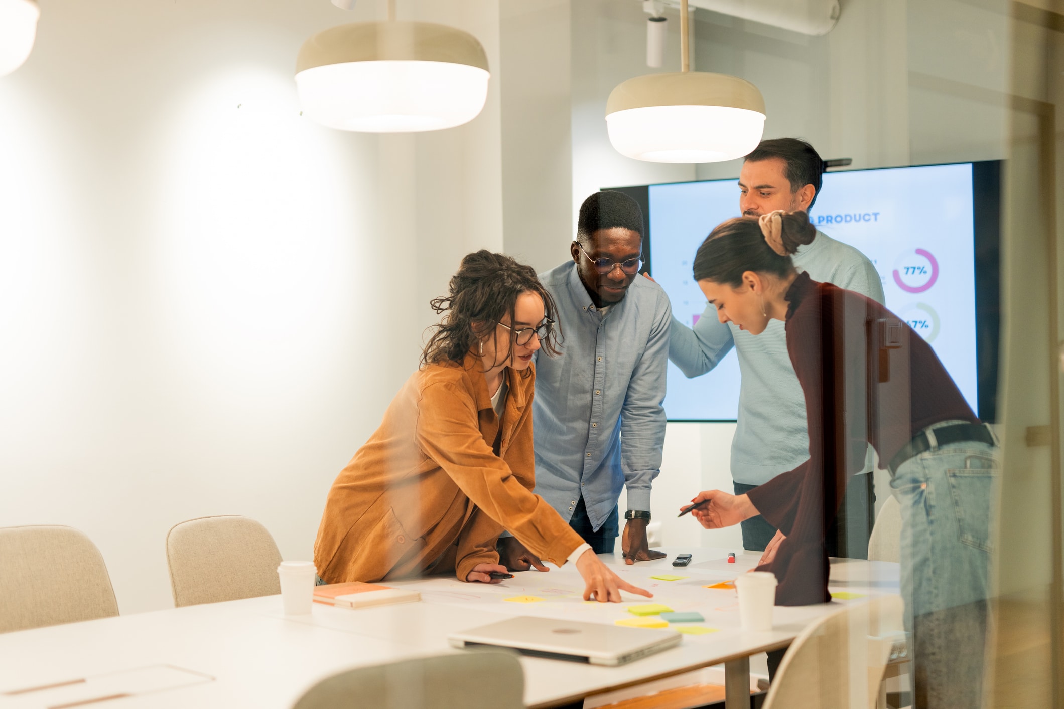 A group of professionals engaged in a venture capital meeting in a modern office setting.